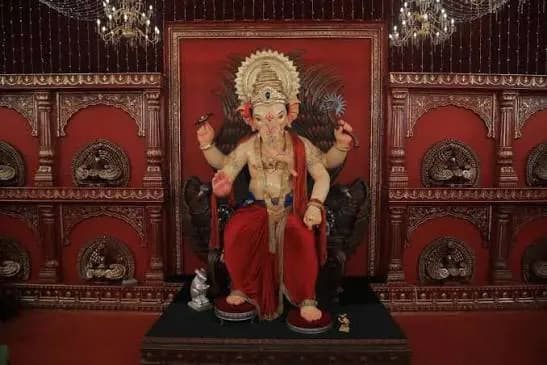 Khetwadicha Ganraj Ganpati idol against a red pandal backdrop in Khetwadi, Mumbai
